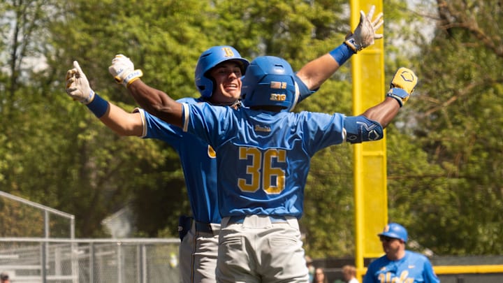 UCLA’s Dean West, left, celebrates his first inning home run with teammate Roman Martin at PK Park in Eugene.