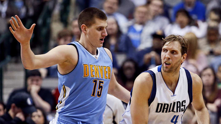 Feb 26, 2016; Dallas, TX, USA; Dallas Mavericks forward Dirk Nowitzki (41) dribbles as Denver Nuggets center Nikola Jokic (15) defends during the game at American Airlines Center.