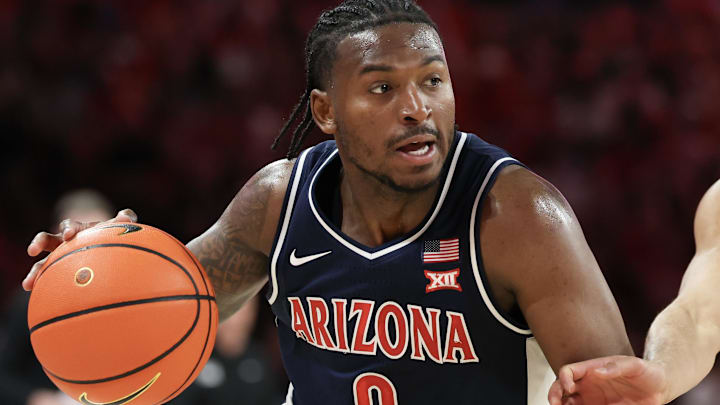 Feb 21, 2026; Houston, Texas, USA;  Arizona Wildcats guard Jaden Bradley (0) dribbles against Houston Cougars guard Milos Uzan (7) in the first half at Fertitta Center. Mandatory Credit: Thomas Shea-Imagn Images