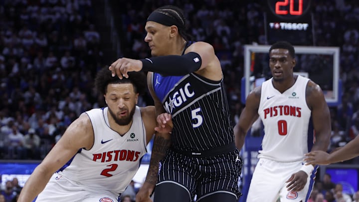 Apr 19, 2026; Detroit, Michigan, USA; Detroit Pistons guard Cade Cunningham (2) dribbles defended by Orlando Magic forward Paolo Banchero (5) in the second half during the 2026 NBA Playoffs at Little Caesars Arena. Mandatory Credit: Rick Osentoski-Imagn Images