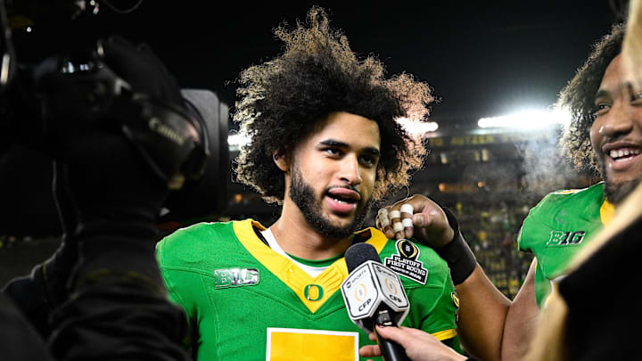 Dec 20, 2025; Eugene, OR, USA;  Oregon Ducks quarterback Dante Moore (5) is interviewed after the game against the James Madison Dukes at Autzen Stadium. Mandatory Credit: Troy Wayrynen-Imagn Images