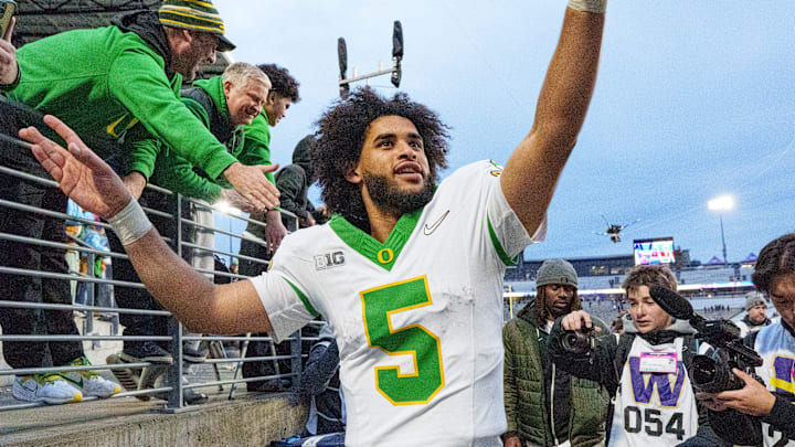 Oregon quarterback Dante Moore celebrates after the game as the Oregon Ducks take on the Washington Huskies on Nov. 29, 2025, at Husky Stadium in Seattle, Washington. Oregon quarterback Dante Moore celebrates after the game as the Oregon Ducks take on the Washington Huskies on Nov. 29, 2025, at Husky Stadium in Seattle, Washington.