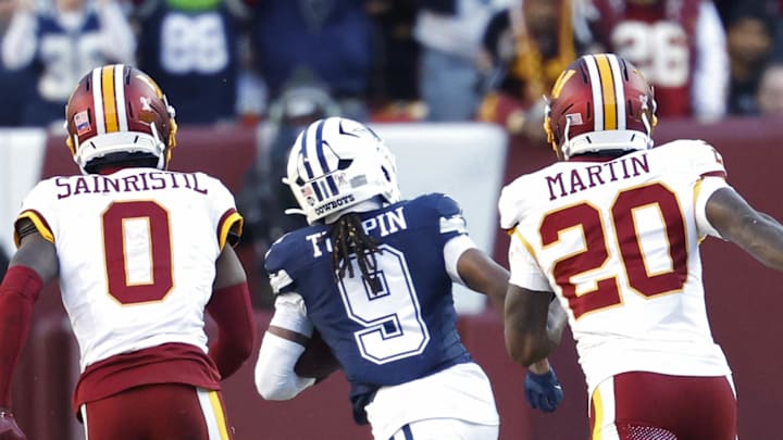 Dec 25, 2025; Landover, Maryland, USA; Dallas Cowboys wide receiver Kavontae Turpin (9) runs with the ball after making a catch en route to a touchdown as Washington Commanders cornerback Mike Sainristil (0) and Commanders safety Quan Martin (20) chase during the first half at Northwest Stadium. Mandatory Credit: Geoff Burke-Imagn Images Dec 25, 2025; Landover, Maryland, USA; Dallas Cowboys wide receiver Kavontae Turpin (9) runs with the ball after making a catch en route to a touchdown as Washington Commanders cornerback Mike Sainristil (0) and Commanders safety Quan Martin (20) chase during the first half at Northwest Stadium. Mandatory Credit: Geoff Burke-Imagn Images