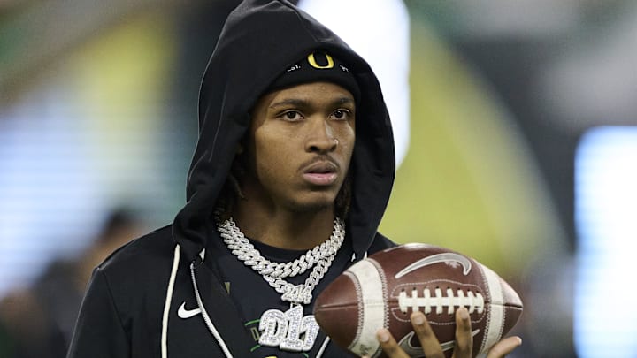 Nov 14, 2025; Eugene, Oregon, USA; Oregon Ducks wide receiver Dakorien Moore (1) watches teammates warm up before a game against the Minnesota Golden Gophers at Autzen Stadium. Mandatory Credit: Troy Wayrynen-Imagn Images Nov 14, 2025; Eugene, Oregon, USA; Oregon Ducks wide receiver Dakorien Moore (1) watches teammates warm up before a game against the Minnesota Golden Gophers at Autzen Stadium. Mandatory Credit: Troy Wayrynen-Imagn Images