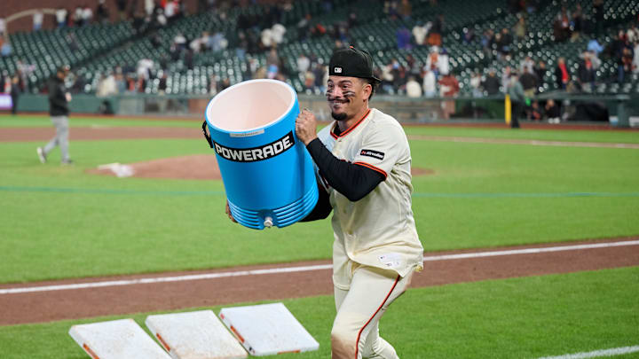 Apr 2, 2026; San Francisco, California, USA; San Francisco Giants infielder Willy Adames (2) carries a cooler on the field before dumping Powerade on catcher Daniel Susac (not pictured) after the game against the New York Mets at Oracle Park. Mandatory Credit: Robert Edwards-Imagn Images