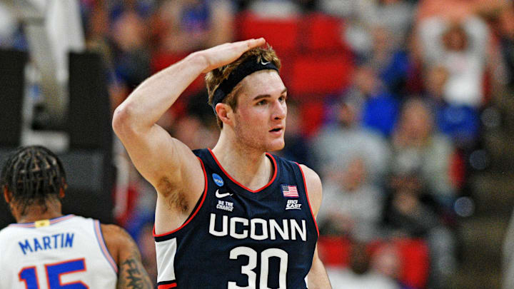 Mar 23, 2025; Raleigh, NC, USA; Connecticut Huskies forward Liam McNeeley (30) reacts after scoring a basket during the second half against the Florida Gators in the second round of the NCAA Tournament at Lenovo Center. Mandatory Credit: Zachary Taft-Imagn Images