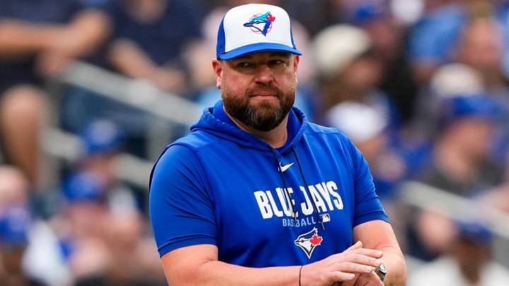 Toronto Blue Jays manager John Schneider (14) walks to the mound.  Credit: Kevin Sousa-Imagn Images