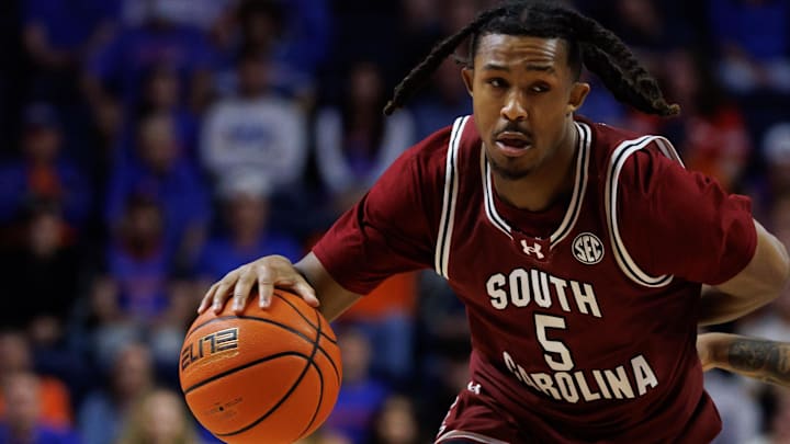 Feb 17, 2026; Gainesville, Florida, USA; South Carolina Gamecocks guard Meechie Johnson (5) drives to the basket while South Carolina Gamecocks forward Elijah Strong (31) screens Florida Gators guard Boogie Fland (0) during the first half at Exactech Arena at the Stephen C. O'Connell Center. Mandatory Credit: Matt Pendleton-Imagn Images