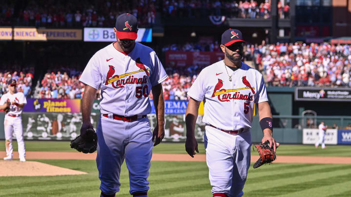 Oct 2, 2022; St. Louis, Missouri, USA;  St. Louis Cardinals catcher Yadier Molina (4) starting pitcher Adam Wainwright (50) and first baseman Albert Pujols (5) walk off the field together after all three were removed from the game during the fifth inning against the Pittsburgh Pirates at Busch Stadium. Mandatory Credit: Jeff Curry-USA TODAY Sports