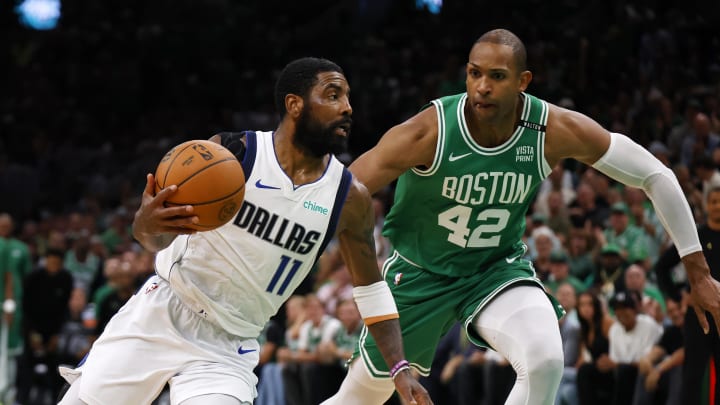 Jun 17, 2024; Boston, Massachusetts, USA; Dallas Mavericks guard Kyrie Irving (11) drives to the basket against Boston Celtics guard Jrue Holiday (left) and center Al Horford (right) during the second quarter in game five of the 2024 NBA Finals at TD Garden. Mandatory Credit: Peter Casey-USA TODAY Sports Jun 17, 2024; Boston, Massachusetts, USA; Dallas Mavericks guard Kyrie Irving (11) drives to the basket against Boston Celtics guard Jrue Holiday (left) and center Al Horford (right) during the second quarter in game five of the 2024 NBA Finals at TD Garden. Mandatory Credit: Peter Casey-USA TODAY Sports