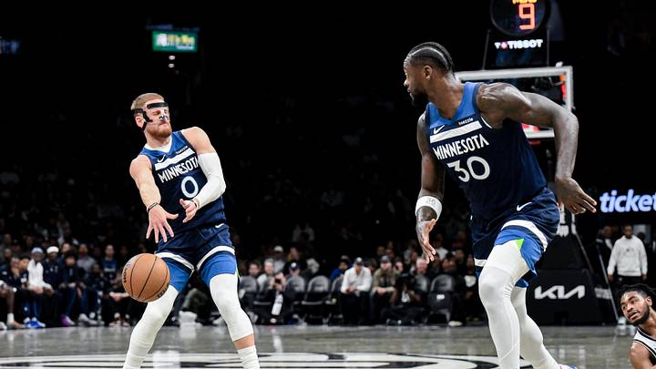 Nov 3, 2025; Brooklyn, New York, USA; Minnesota Timberwolves guard Donte DiVincenzo (0) passes to forward Julius Randle (30) against Brooklyn Nets center Nic Claxton (33) during the first half at Barclays Center. Mandatory Credit: John Jones-Imagn Images Nov 3, 2025; Brooklyn, New York, USA; Minnesota Timberwolves guard Donte DiVincenzo (0) passes to forward Julius Randle (30) against Brooklyn Nets center Nic Claxton (33) during the first half at Barclays Center. Mandatory Credit: John Jones-Imagn Images