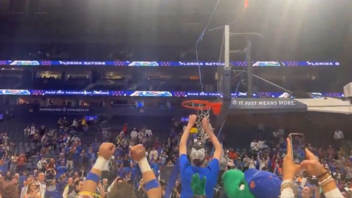 Florida center Olivier Rioux cuts down net after the Gators won the SEC tournament title.