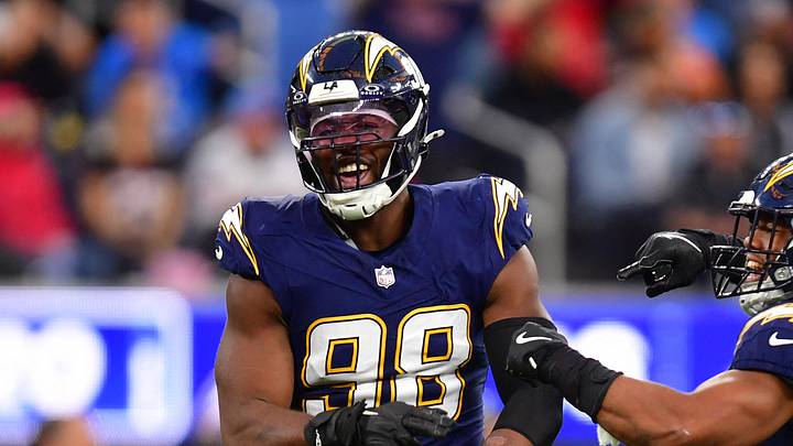 Dec 27, 2025; Inglewood, California, USA;  Los Angeles Chargers linebacker Odafe Oweh (98) and linebacker Daiyan Henley (0) react after a defensive play against the Houston Texans during the second half at SoFi Stadium. Mandatory Credit: Gary A. Vasquez-Imagn Images