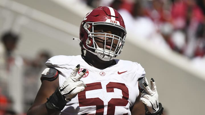 Alabama offensive lineman Tyler Booker (52) celebrates after the offense scored a touchdown Alabama offensive lineman Tyler Booker (52) celebrates after the offense scored a touchdown