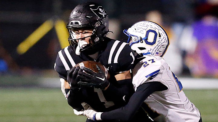 Ontario High School's Tre Fowler (27) tackles Perkins High School's Braylon Collier (1) during their OHSAA Division IV Region 14 championship high school football game Friday, Nov. 22, 2024 at Tiffin Frost Kalnow Stadium. TOM E. PUSKAR/MANSFIELD NEWS JOURNAL