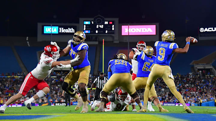 Aug 30, 2025; Pasadena, California, USA; UCLA Bruins quarterback Nico Iamaleava (9) throws as offensive lineman Courtland Ford (77) provides coverage against Utah Utes defensive end John Henry Daley (90) during the first half at Rose Bowl. Mandatory Credit: Gary A. Vasquez-Imagn Images