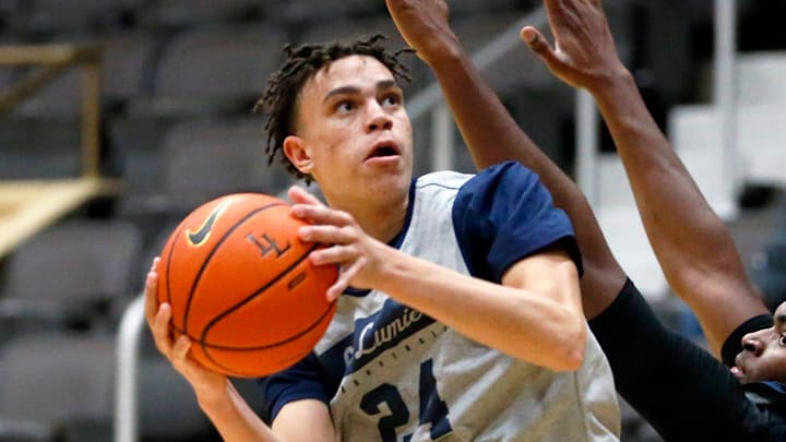 La Lumiere junior Darius Adams looks to put up a shot around teammate Jonas Muya during an open practice Thursday, Nov. 9, 2023, at the La Porte Civic Auditorium.