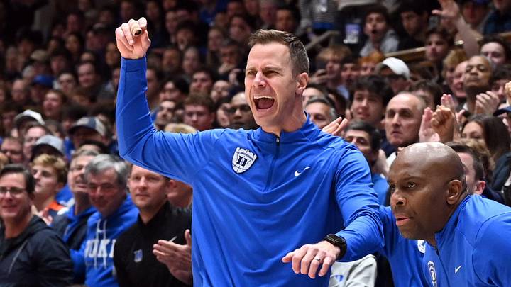 Feb 28, 2026; Durham, North Carolina, USA;Duke Blue Devils head coach Jon Scheyer (left) reacts during the first half against the Virginia Cavaliers at Cameron Indoor Stadium. Mandatory Credit: Rob Kinnan-Imagn Images