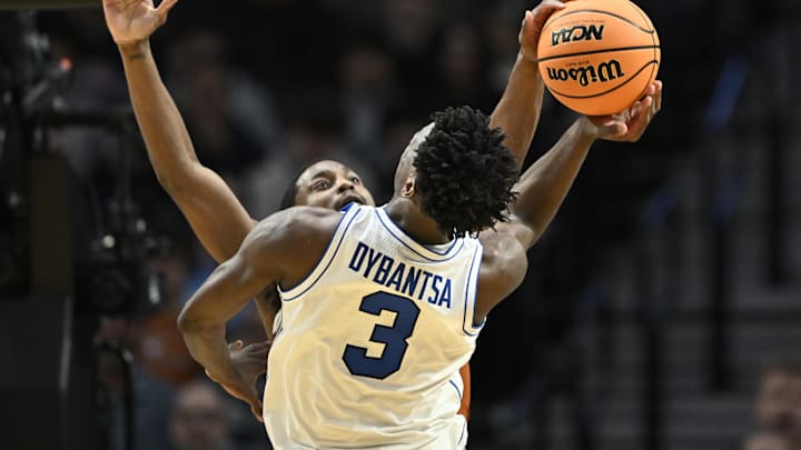 Mar 19, 2026; Portland, OR, USA; Texas Longhorns guard Tramon Mark (12) blocks BYU Cougars forward AJ Dybantsa (3) in the second half during a first round game of the men's 2026 NCAA Tournament at Moda Center. Mandatory Credit: Craig Strobeck-Imagn Images