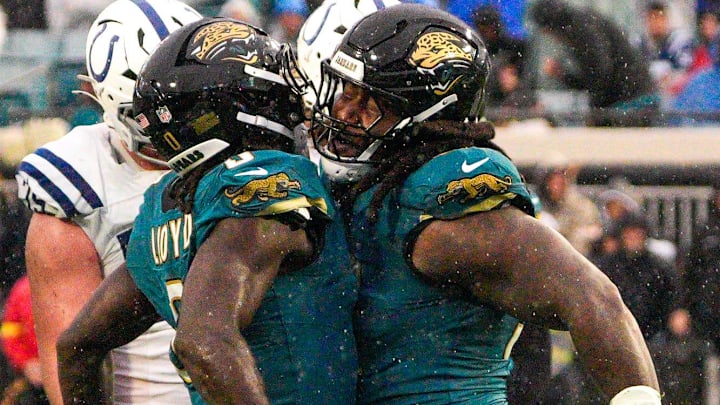 Jacksonville Jaguars linebacker Devin Lloyd (0) chests bumps Jacksonville Jaguars defensive tackle DaVon Hamilton (52) after tackling Indianapolis Colts running back Jonathan Taylor (28) in the third quarter during an NFL football game at EverBank Stadium, Sunday, Dec. 7, 2025, in Jacksonville, Fla. Jaguars won 36-19. [Doug Engle/Florida Times-Union]