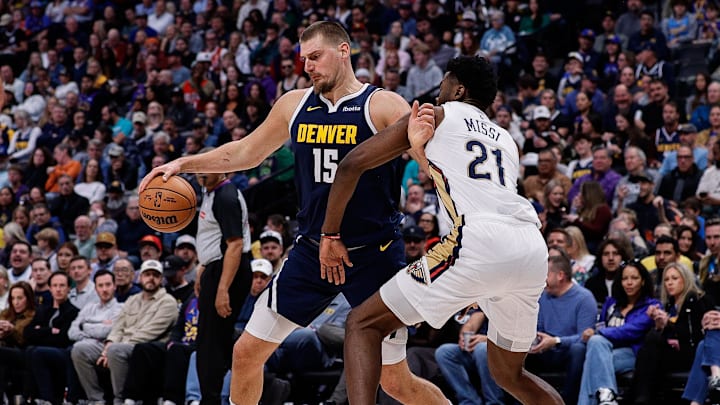 Oct 29, 2025; Denver, Colorado, USA; Denver Nuggets center Nikola Jokic (15) controls the ball as New Orleans Pelicans center Yves Missi (21) defends in the third quarter at Ball Arena. Mandatory Credit: Isaiah J. Downing-Imagn Images