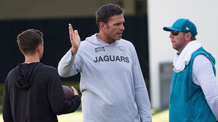 Jacksonville Jaguars General Manager James Gladstone, left and Jaguars Executive Vice President of Football Operations Tony Boselli, center, all talk with Jacksonville Jaguars Head Coach Liam Coen after the Jacksonville Jaguars’ 18th and final training camp practice at Miller Electric Center in Jacksonville, Fla. Wednesday August 20, 2025. [Doug Engle/Florida Times-Union]