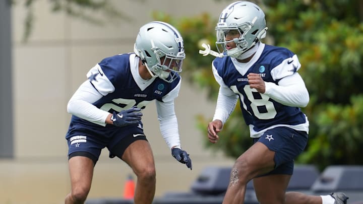 Dallas Cowboys cornerback Devin Moore and safety Caleb Downs go through a drill during practice at the Ford Center.