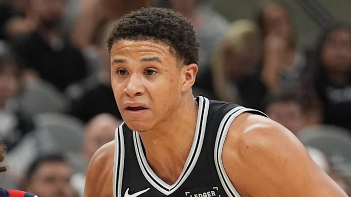 Nov 8, 2025; San Antonio, Texas, USA;  New Orleans Pelicans guard Jose Alvarado (15) dribbles against San Antonio Spurs forward Carter Bryant (11) in the first half at Frost Bank Center. Mandatory Credit: Daniel Dunn-Imagn Images