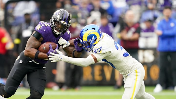 Oct 12, 2025; Baltimore, Maryland, USA; Baltimore Ravens running back Derrick Henry (22) carries the ball defended by Los Angeles Rams safety Quentin Lake (37) during the second half of the game at M&T Bank Stadium. Mandatory Credit: Mitch Stringer-Imagn Images Oct 12, 2025; Baltimore, Maryland, USA; Baltimore Ravens running back Derrick Henry (22) carries the ball defended by Los Angeles Rams safety Quentin Lake (37) during the second half of the game at M&T Bank Stadium. Mandatory Credit: Mitch Stringer-Imagn Images