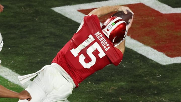 Jan 19, 2026; Miami Gardens, FL, USA; Indiana Hoosiers quarterback Fernando Mendoza (15) carries the ball for a touchdown against the Miami Hurricanes in the fourth quarter during the College Football Playoff National Championship game at Hard Rock Stadium. Mandatory Credit: Kim Klement Neitzel-Imagn Images