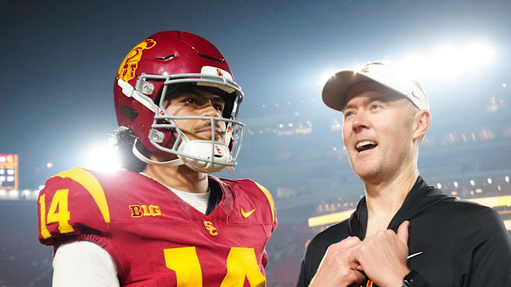 Nov 29, 2025; Los Angeles, California, USA; Southern California Trojans quarterback Jayden Maiava (14) and head coach Lincoln Riley react after the game against the UCLA Bruins at United Airlines Field at Los Angeles Memorial Coliseum. 