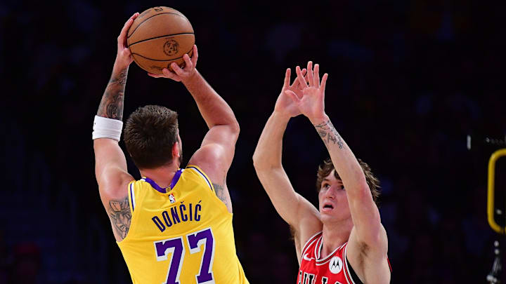 Mar 12, 2026; Los Angeles, California, USA; Los Angeles Lakers guard Luka Doncic (77) shoots against Chicago Bulls forward Matas Buzelis (14) during the second half at Crypto.com Arena. Mandatory Credit: Gary A. Vasquez-Imagn Images
