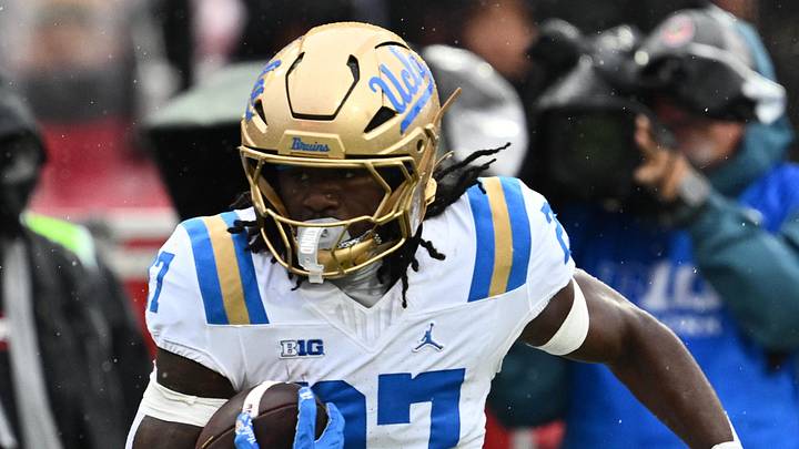 Sep 26, 2026; College Park, Maryland, USA; UCLA Bruins defensive back Ta'Shawn James (27) gets past Maryland Terrapins quarterback Malik Washington (7) to return an interception for a touchdown in the second half at SECU Stadium. Mandatory Credit: Jamie Sabau-Imagn Images Sep 26, 2026; College Park, Maryland, USA; UCLA Bruins defensive back Ta'Shawn James (27) gets past Maryland Terrapins quarterback Malik Washington (7) to return an interception for a touchdown in the second half at SECU Stadium. Mandatory Credit: Jamie Sabau-Imagn Images