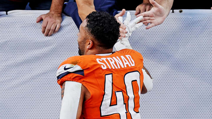 Oct 19, 2025; Denver, Colorado, USA; Denver Broncos linebacker Justin Strnad (40) celebrates the win against the New York Giants with the fans at Empower Field at Mile High. Mandatory Credit: Isaiah J. Downing-Imagn Images