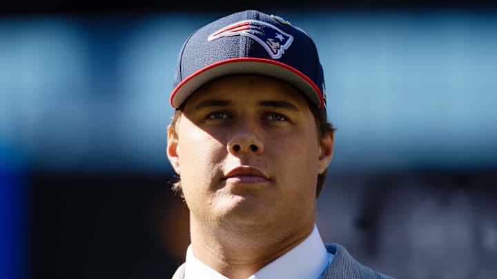 New England Patriots first-round draft pick Caleb Lomu walks to the podium during a press conference.