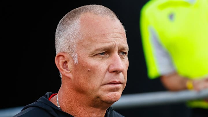 Aug 28, 2025; Raleigh, North Carolina, USA; North Carolina State Wolfpack head coach Dave Doeren walks out during the warmups prior to the game against East Carolina Pirates at Carter-Finley Stadium. Mandatory Credit: Jaylynn Nash-Imagn Images