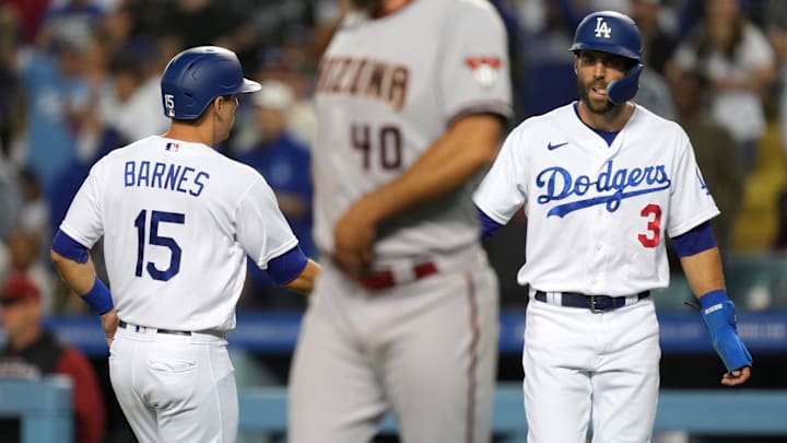 Los Angeles Dodgers catcher Austin Barnes (15) celebrates with designated hitter Chris Taylor (3) after scoring in the fifth inning as Arizona Diamondbacks starting pitcher Madison Bumgarner (40) reacts at Dodger Stadium on May 16, 2022.