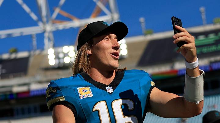 Jacksonville Jaguars quarterback Trevor Lawrence (16) makes a social media post while walking off the field after the game of an NFL football matchup at EverBank Stadium on Sunday, Sept. 27, 2026, in Jacksonville, Fla. The Jaguars defeated the Patriots 35-6. 