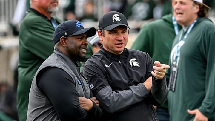 Michigan State's head coach Jonathan Smith, right, talks with UCLA's interim head coach Tim Skipper before the football game on Saturday, Oct. 11, 2025, at Spartan Stadium in East Lansing.