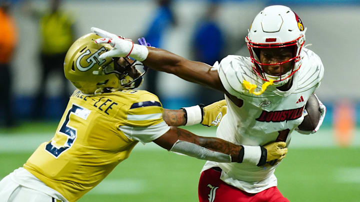 Sep 1, 2023; Atlanta, Georgia, USA;  Louisville Cardinals wide receiver Jamari Thrash (1) carries the ball up the field against Georgia Tech Yellow Jackets defensive back Clayton Powell-Lee (5) during the second half at Mercedes-Benz Stadium. Mandatory Credit: John David Mercer-Imagn Images