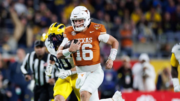 Texas Longhorns quarterback Arch Manning rushes with the ball for a touchdown against the Michigan Wolverines.