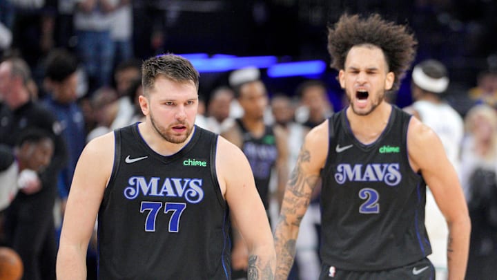 May 24, 2024; Minneapolis, Minnesota, USA; Dallas Mavericks guard Luka Doncic (77) and center Dereck Lively II (2) celebrate in the fourth quarter against the Minnesota Timberwolves in game two of the western conference finals for the 2024 NBA playoffs at Target Center. Mandatory Credit: Brad Rempel-Imagn Images