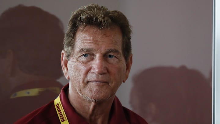 Jul 26, 2018; Richmond, VA, USA; Former Washington Redskins quarterback Joe Theismann listens as Redskins quarterback Alex Smith (not pictured) speaks with the media after practice on day one of Redskins training camp at Bon Secours Washington Redskins Training Cent. Mandatory Credit: Geoff Burke-Imagn Images