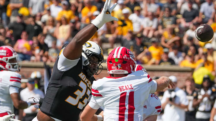 Sep 13, 2025; Columbia, Missouri, USA; Louisiana-Lafayette Ragin Cajuns quarterback Daniel Beale (11) throws a pass as Missouri Tigers defensive tackle Marquis Gracial (33) tries to block during the first half of the game at Faurot Field at Memorial Stadium. Mandatory Credit: Denny Medley-Imagn Images