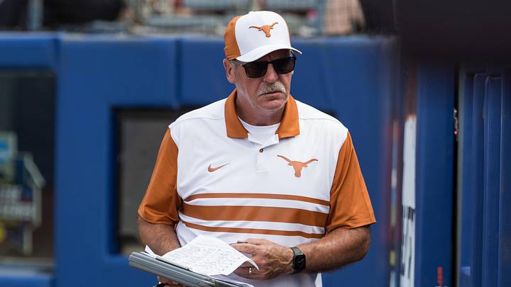 Texas Longhorns head coach Mike White looks into his dugout in the seventh inning against the Tennessee Lady Volunteers.