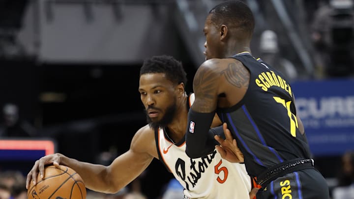 Jan 9, 2025; Detroit, Michigan, USA;  Detroit Pistons guard Malik Beasley (5) dribbles against Golden State Warriors guard Dennis Schroder (71) in the first half at Little Caesars Arena. Mandatory Credit: Rick Osentoski-Imagn Images