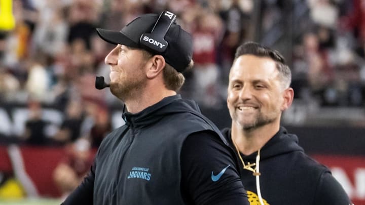 Nov 23, 2025; Glendale, Arizona, USA; Jacksonville Jaguars quarterback Trevor Lawrence (16) celebrates with head coach Liam Coen after defeating the Arizona Cardinals at State Farm Stadium. Mandatory Credit: Mark J. Rebilas-Imagn Images