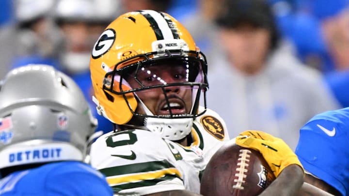 Green Bay Packers running back Josh Jacobs (8) runs the ball against the Detroit Lions.