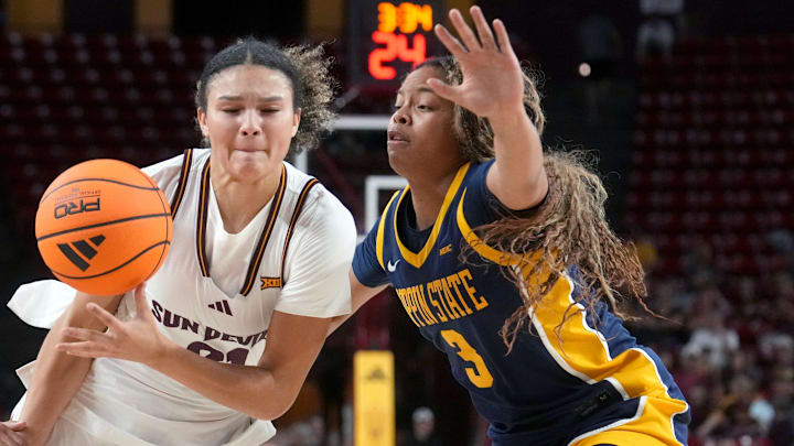 ASU Sun Devils forward McKinna Brackens (21) drives past Coppin State Bald Eagles guard Kylie Wells (5) at Desert Financial Arena on Nov. 3, 2025.