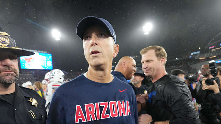 Jan 2, 2026; San Diego, CA, USA; Arizona Wildcats head coach Brent Brennan reacts after shaking hands with SMU Mustangs head coach Rhett Lashlee in the Holiday Bowl at Snapdragon Stadium. Mandatory Credit: Kirby Lee-Imagn Images